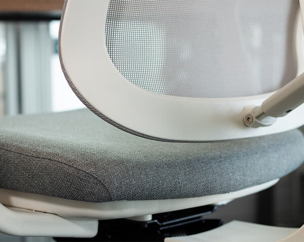 person sitting on ascent chair with closeup of lumbar support